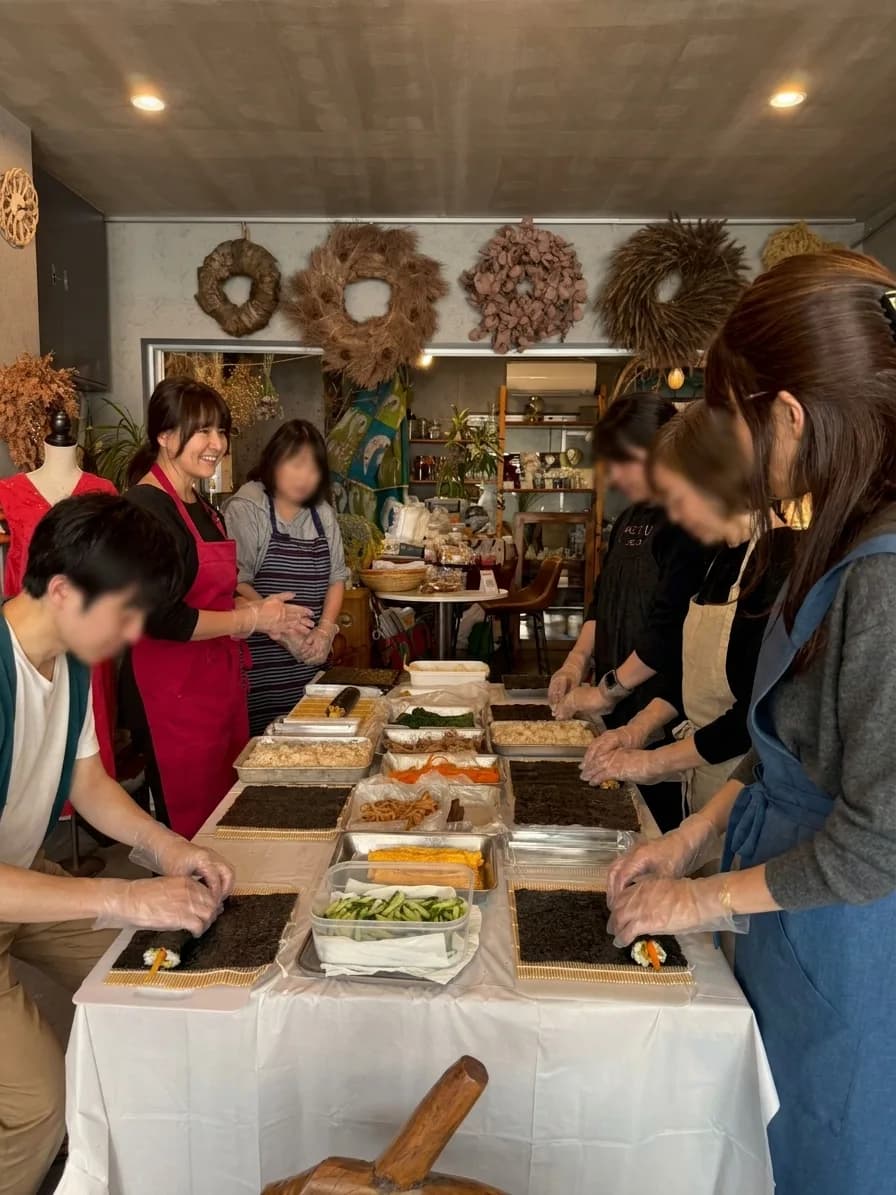 長いテーブルを囲んでキンパを巻く教室のようす
